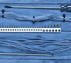 Electrical cables and tools laid out on a workbench